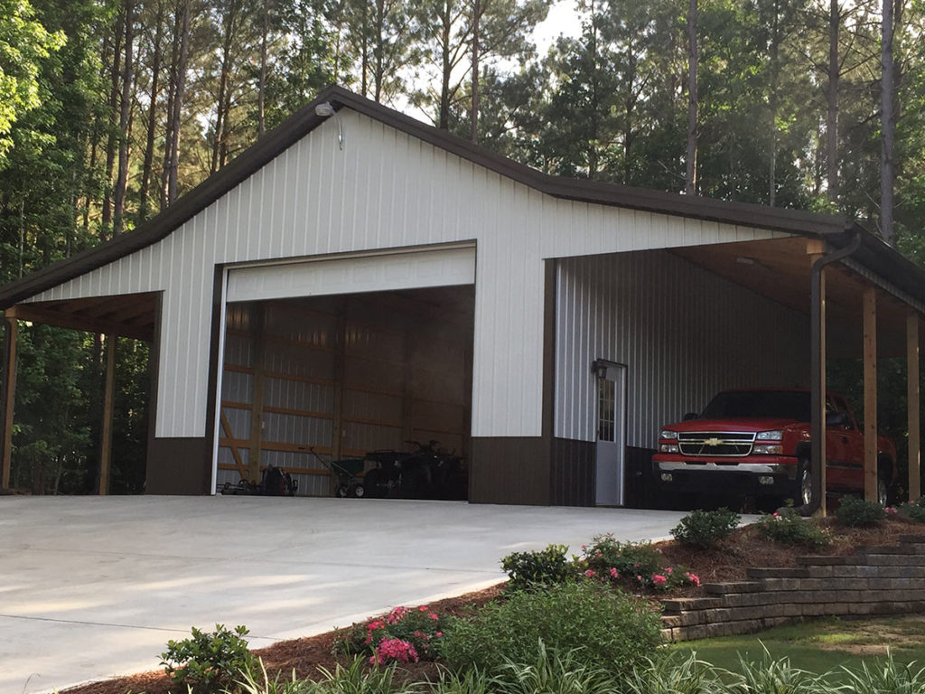 Pole barn garage with overhead door and lean-tos on each side.