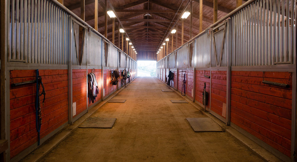 A horse pole barn being illuminated with pole barn lighting fixtures